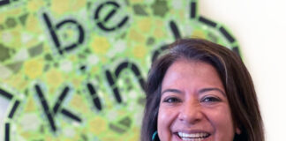 Helen Gomez smiling in front of the Ben’s Bells logo.
